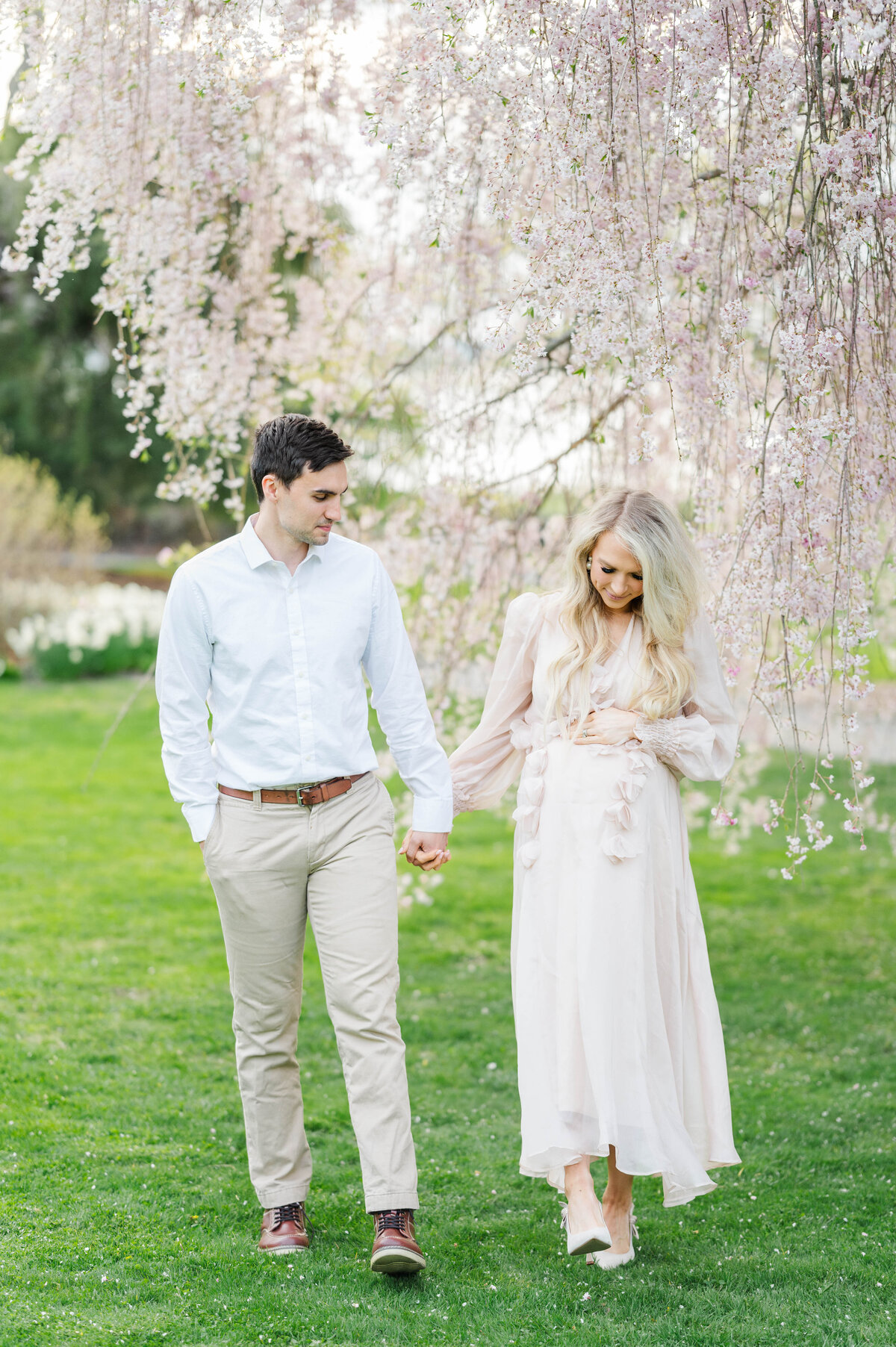 Husband and wife walking in Bristol, RI at Blithewold Mansion taken by best Maternity photographer in Rhode Island