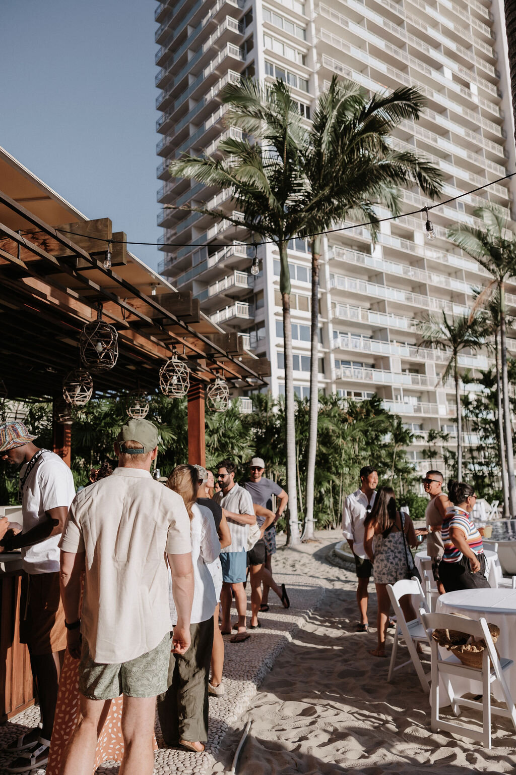 guests at post wedding pool party standing by the bar talking