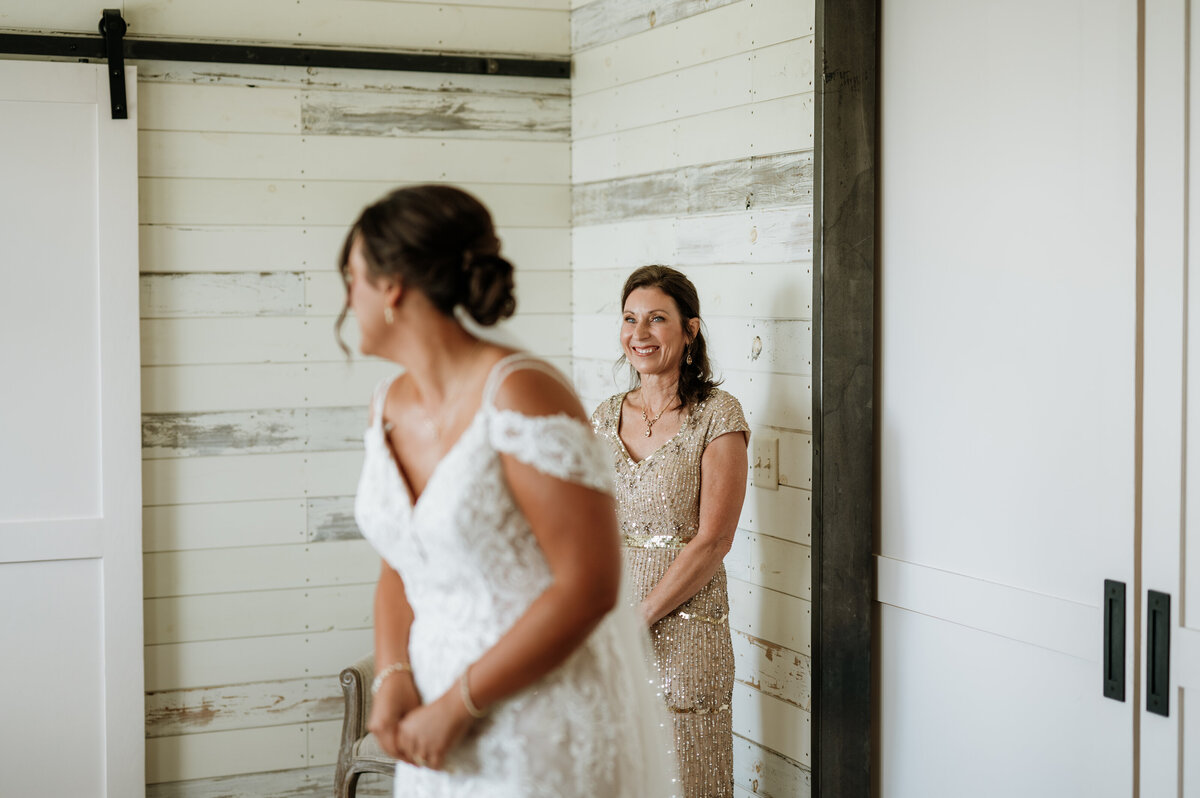 Bride laughing with bridesmaids before ceremony