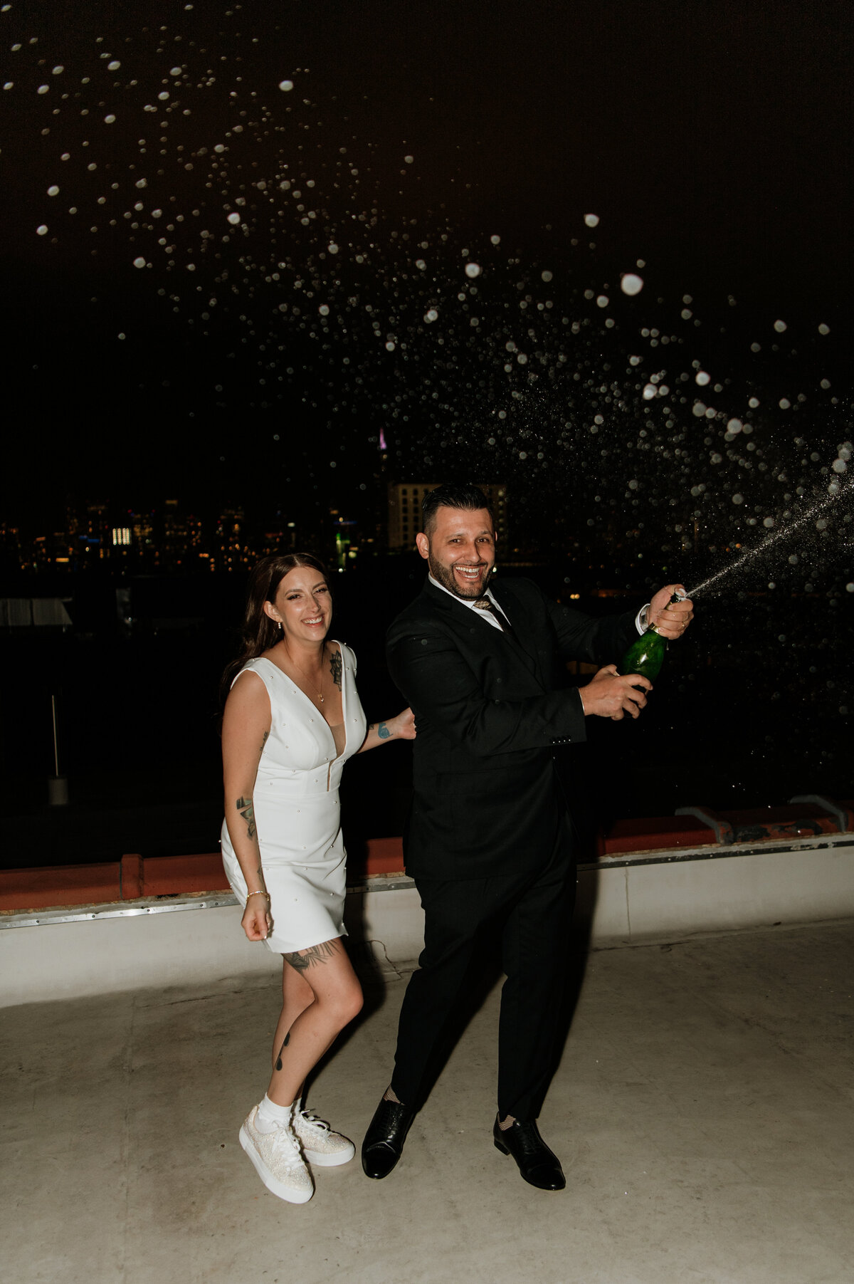 Bride tossing bouquet under night sky South Bend