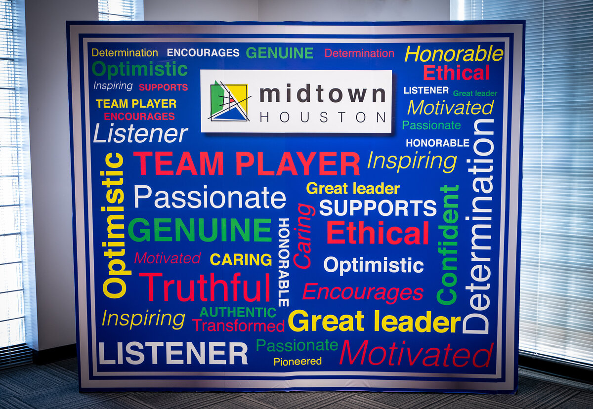 Midtown Houston corporate event blue backdrop with leadership words