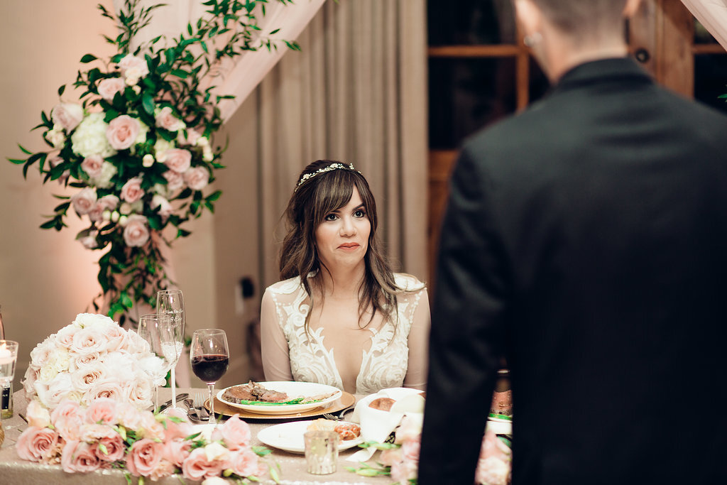 Wedding Photograph Of Bride Looking Up At Her Groom While Seated Los Angeles