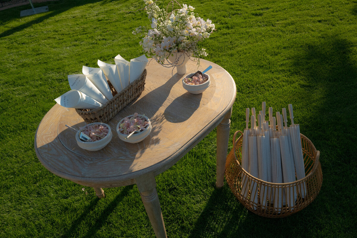 Whicker basket with parasols and table with fans  for guests