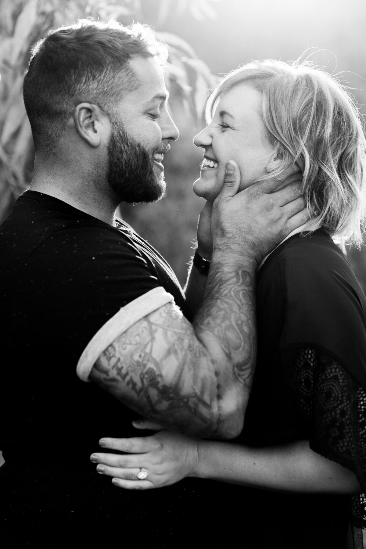 engaged couple posing together for engagement photo in black and white photo