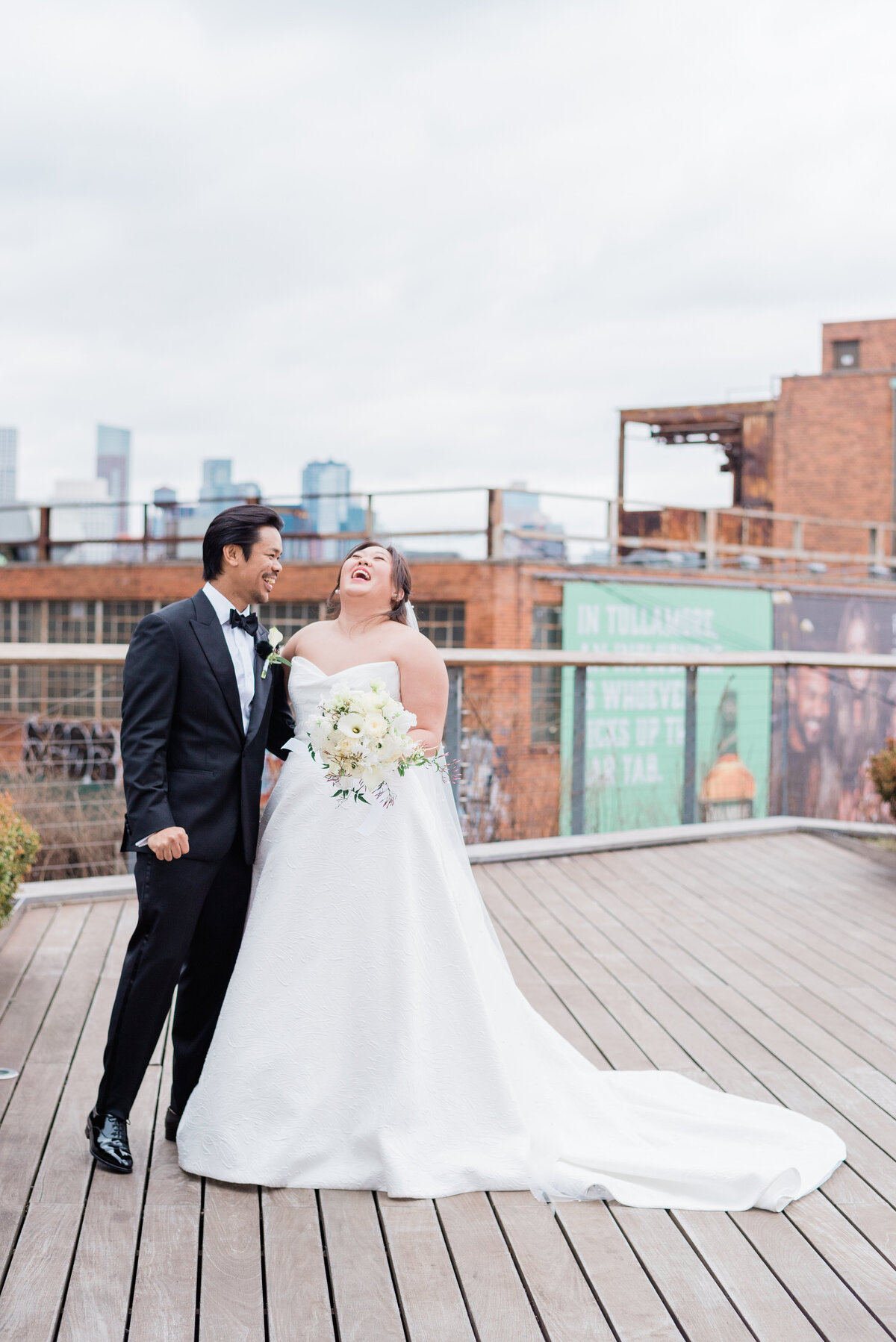 Newlyweds laugh on a Brooklyn NYC rooftop