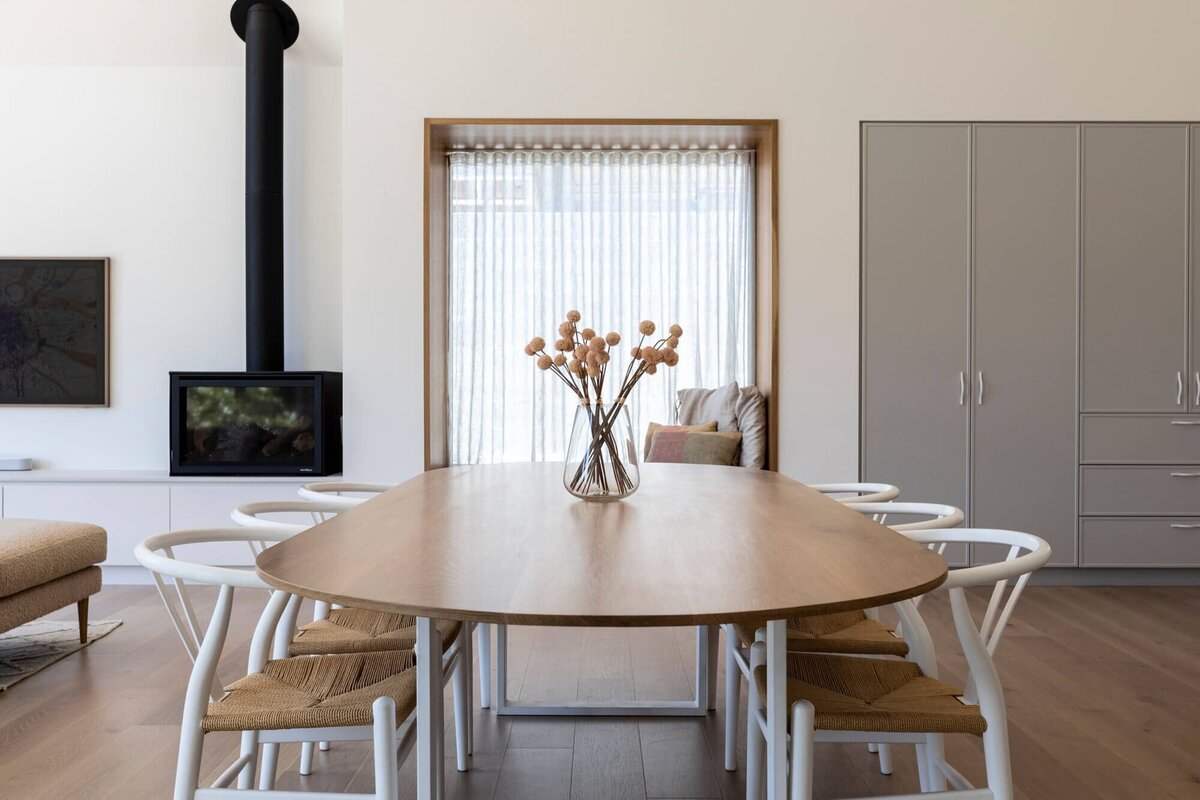 kitchen table with a stove in the background and grey kitchen cupboards too