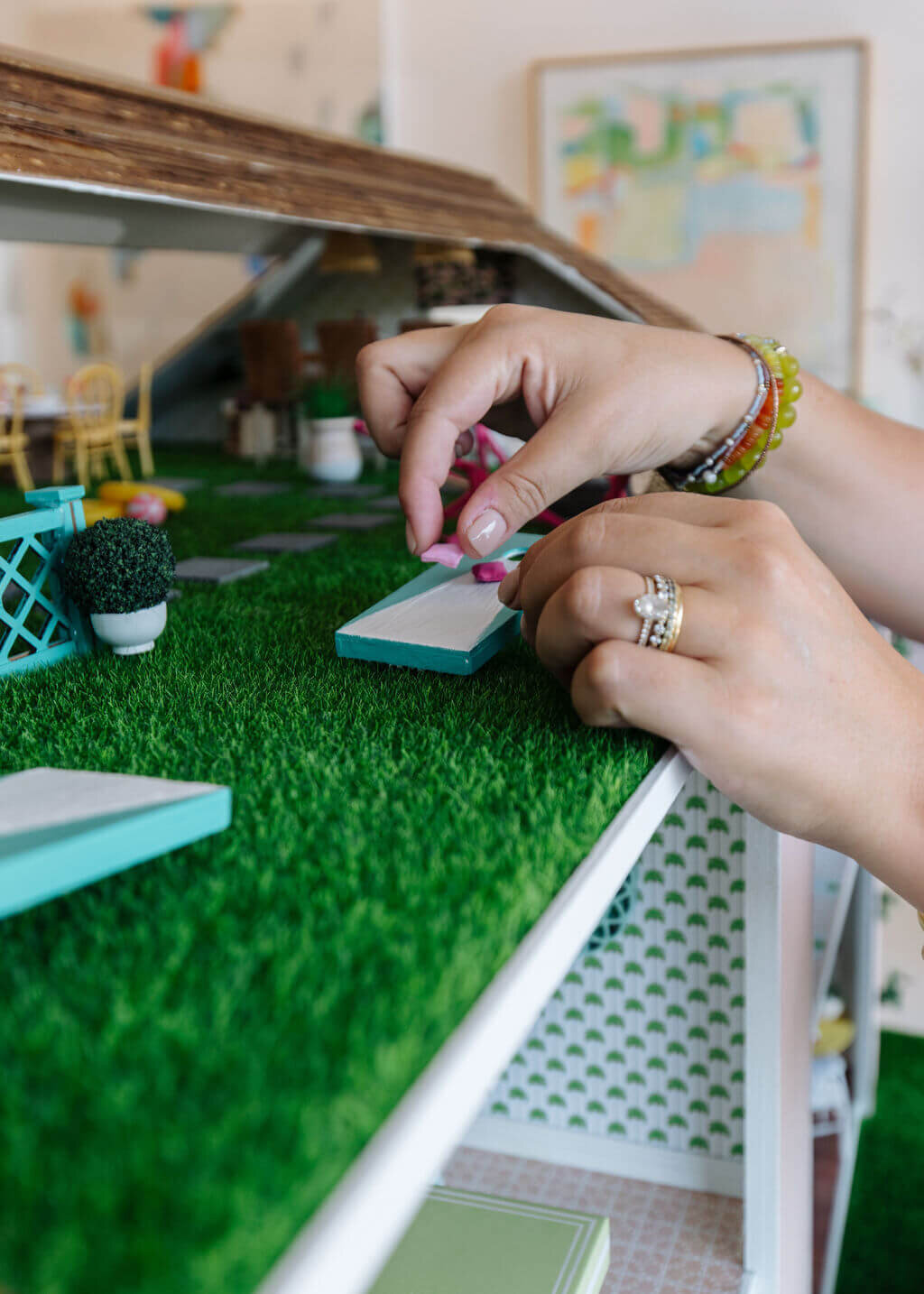 oyster creek studios petite palm beach dollhouse interior designer adjusting corn hole on turf
