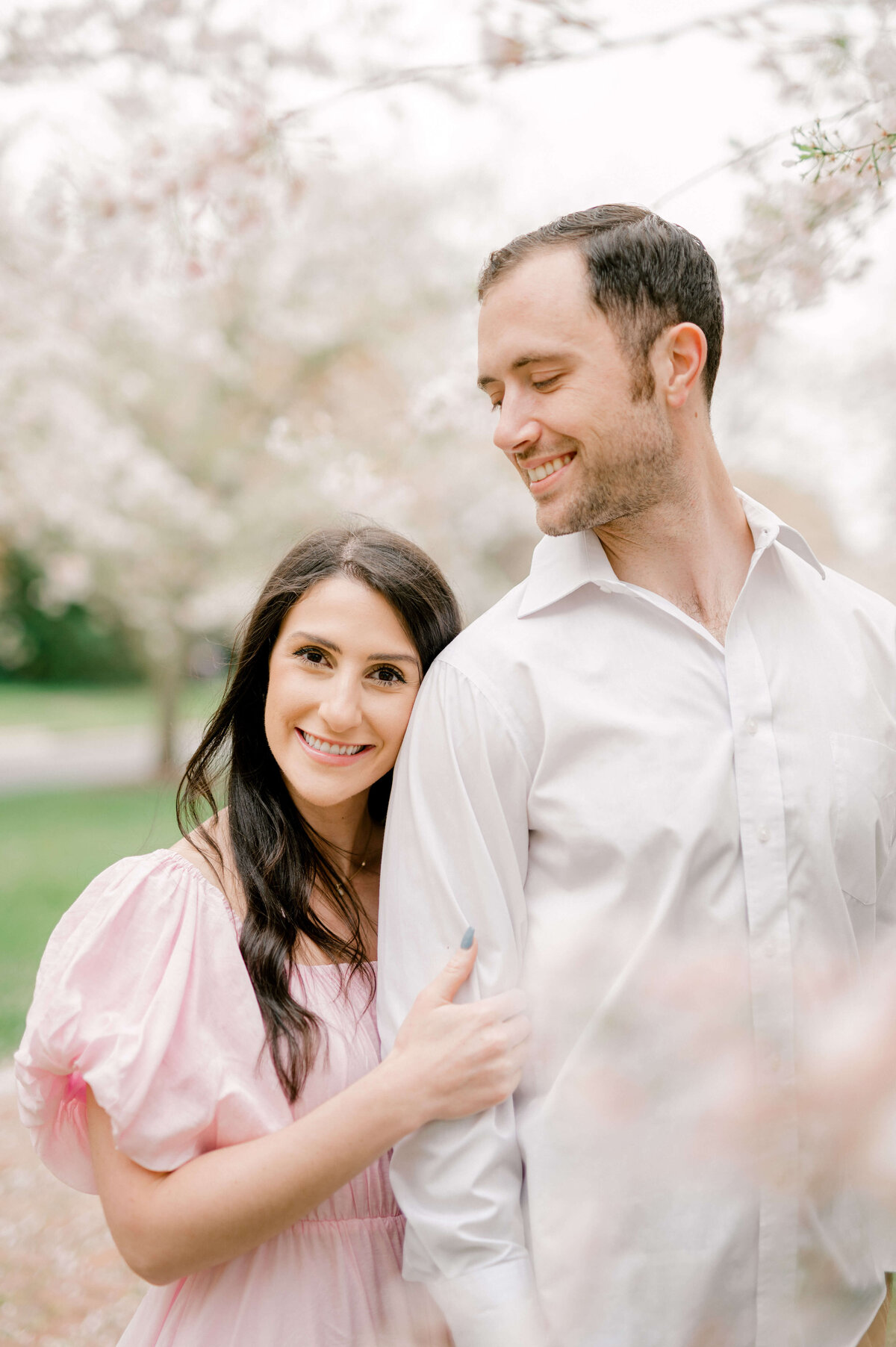 Woman holding onto fiance's arm for photos by Virginia Wedding Photographer, Rachael Mattio