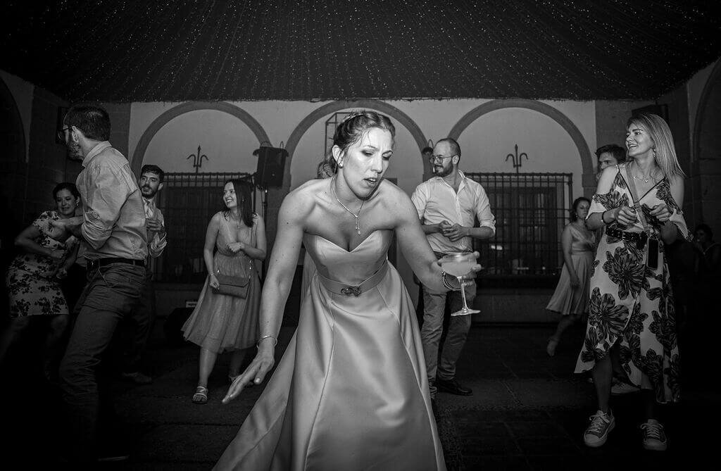 Bride dances on dancefloor at her wedding reception in Madrid