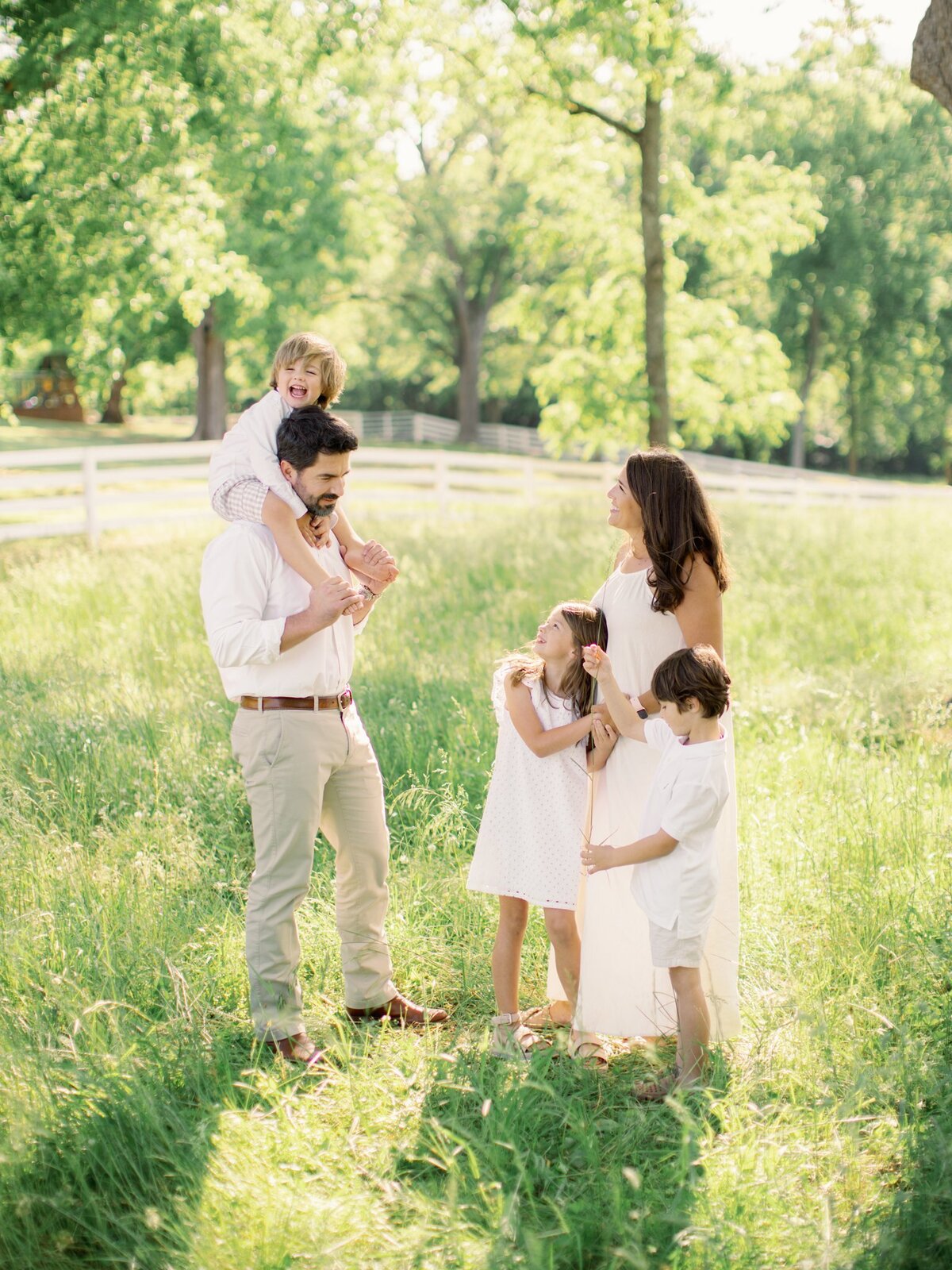family of five interacting in field