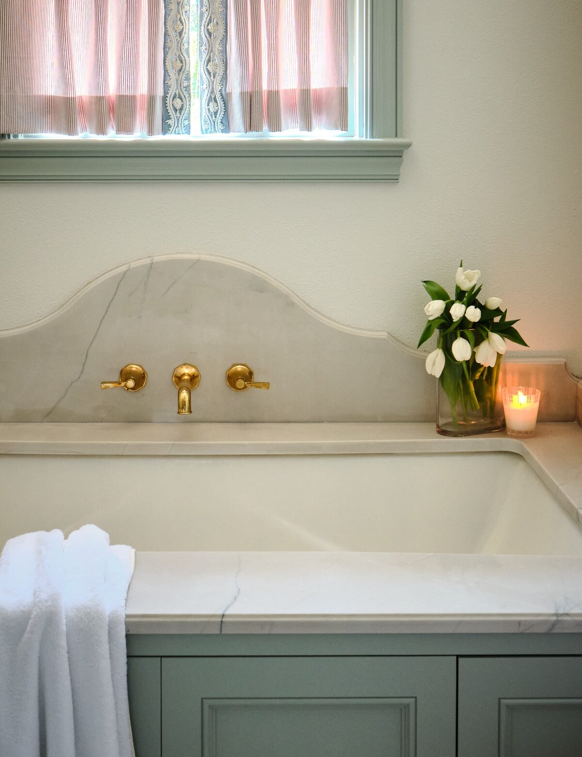 the keeping room interiors morningside bathtub with lit candle and gold faucet