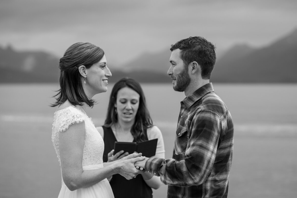 An officiant reads during a bride and groom's wedding ceremony in Alaska.