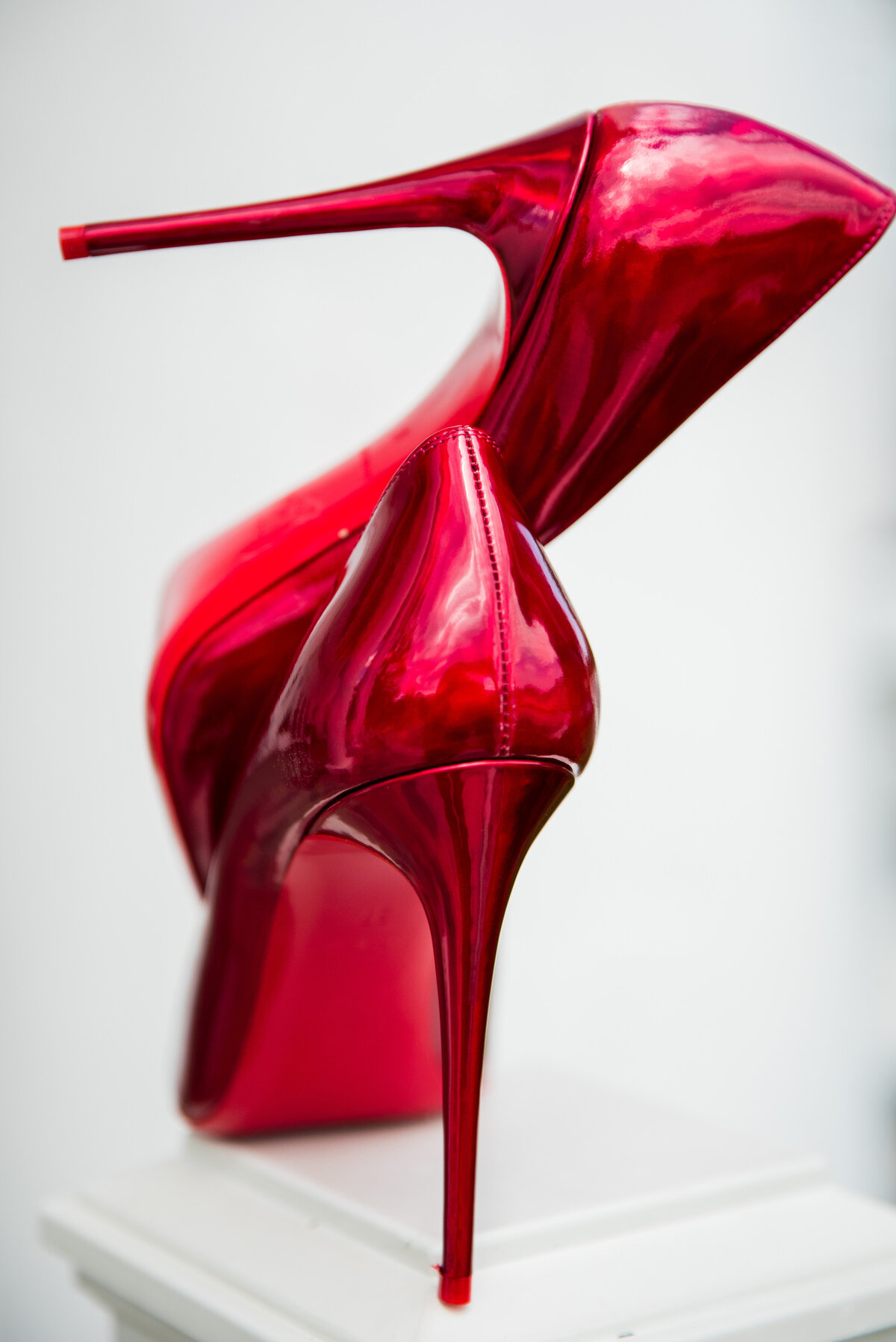A pair of metallic red wedding heels.
