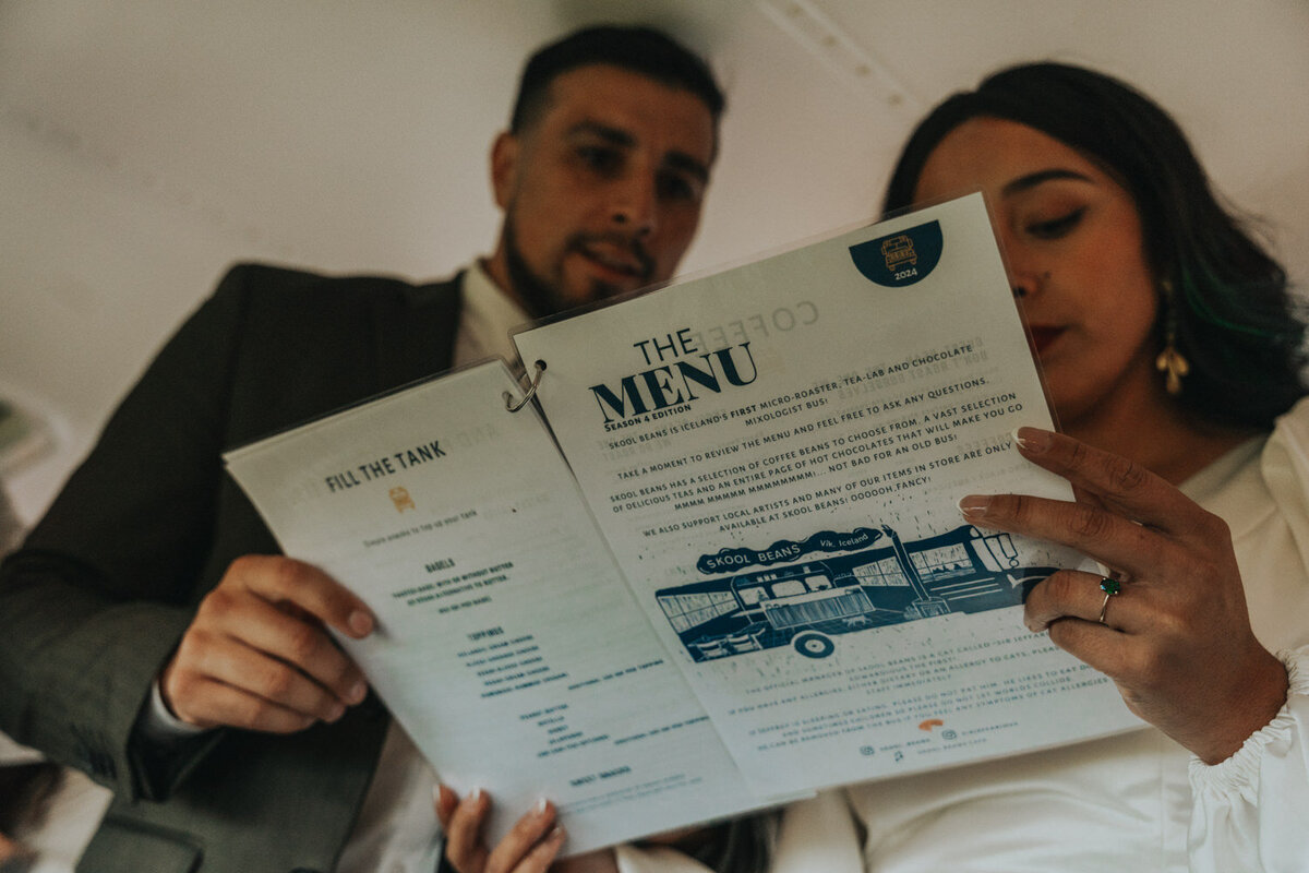 Couple reads the menu of a coffee cart 
