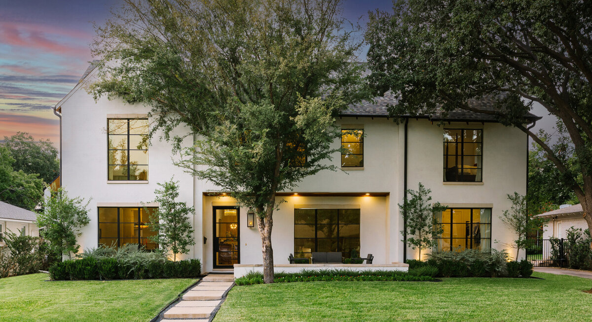 Exterior of a two story luxury north Dallas home with expansive windows