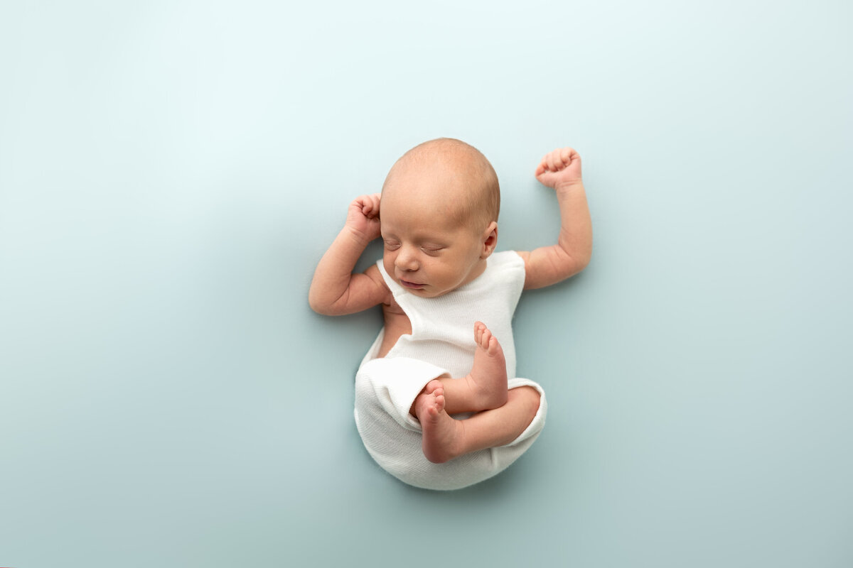 Edmonton studio newborn table pose with blue backdrop