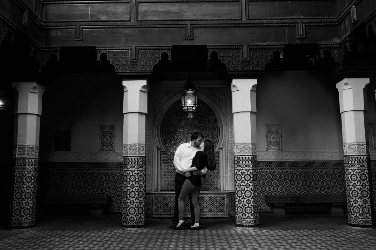 Black and white photo of couple kissing at Disney