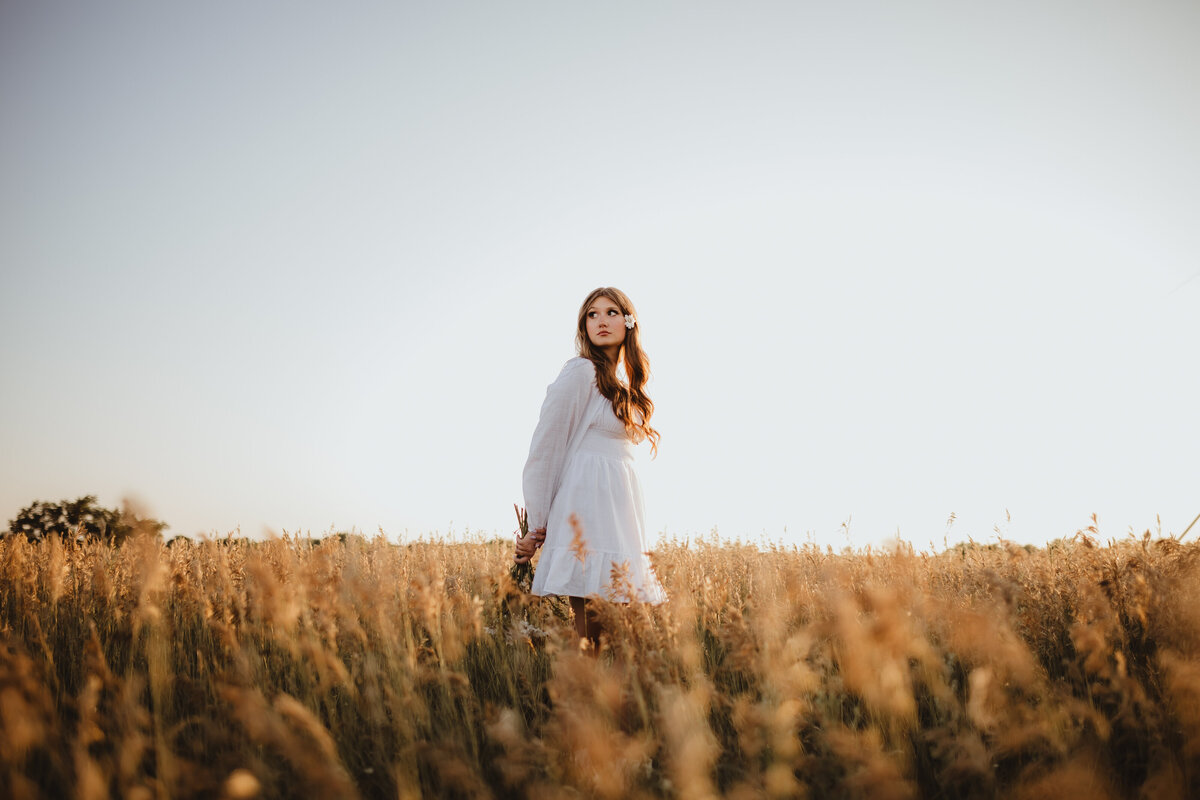 WHITE DRESS IN FIELD WITH FLOWER IN HAIR