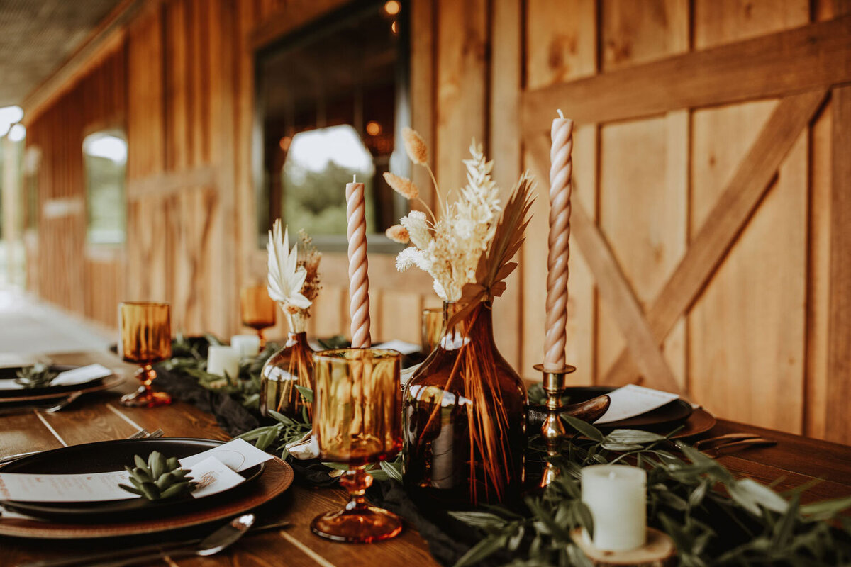 Rustic table setup with amber glassware and candlelit decor