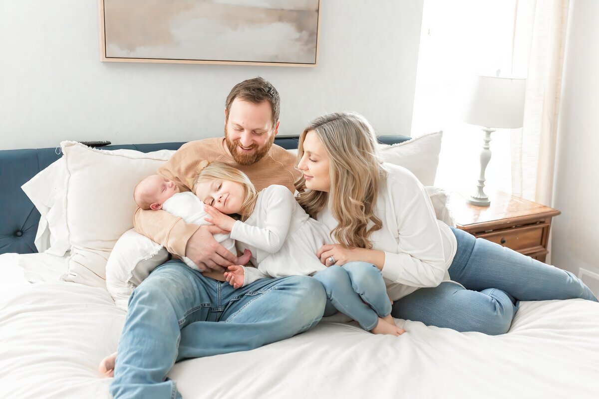 Family interacting on bed taken  by Brooke Leigh Photography during lifestyle newborn session