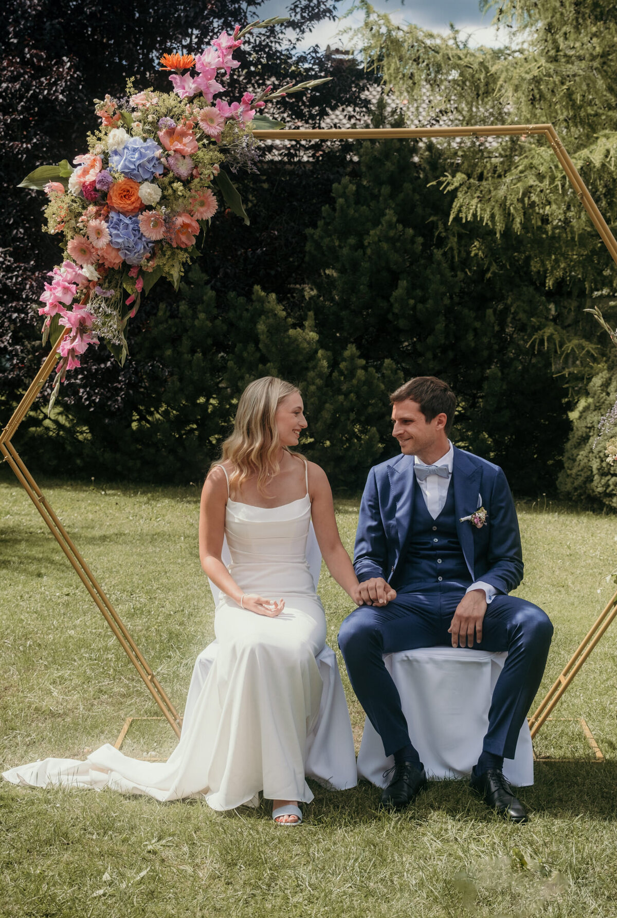 At the moment before the wedding vows, the couple shares an excited eyecontact.