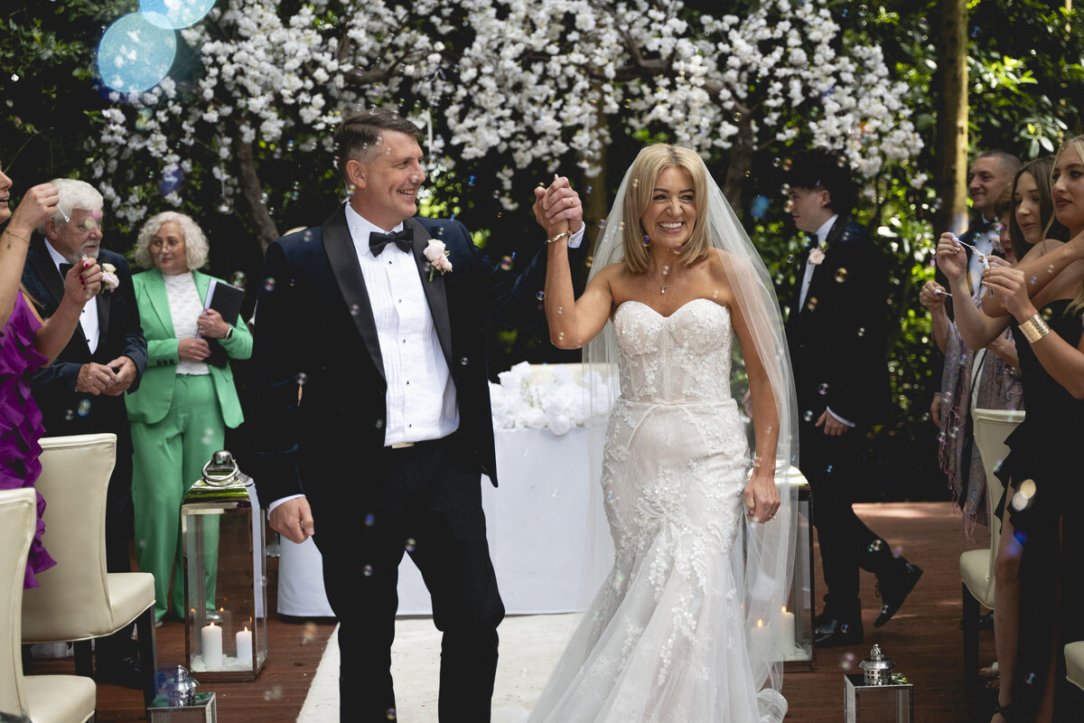 The couple walking back out of their ceremony