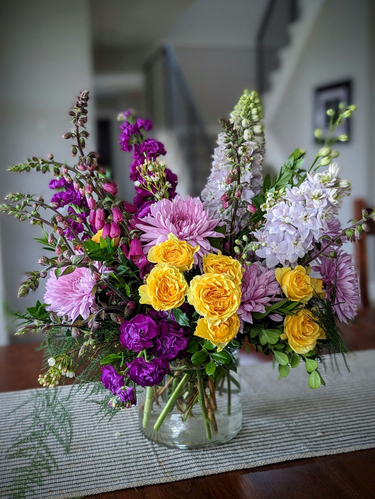 white funeral flowers with purple and yellow in vase 2