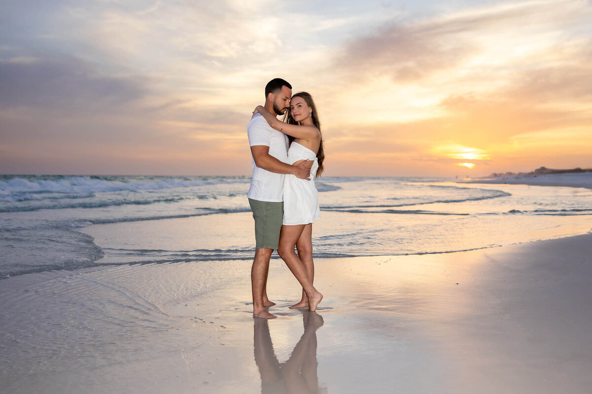 newly married couple honeymooning on 30a taking pictures at grayton beach state park on the beach with sunset.