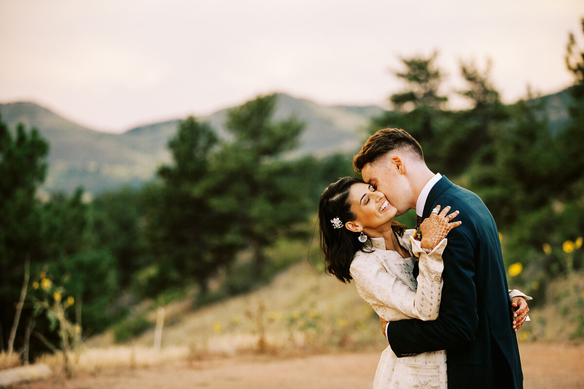 Kissing wedding couple at Lionsgate Manor in Lyons, Colorado