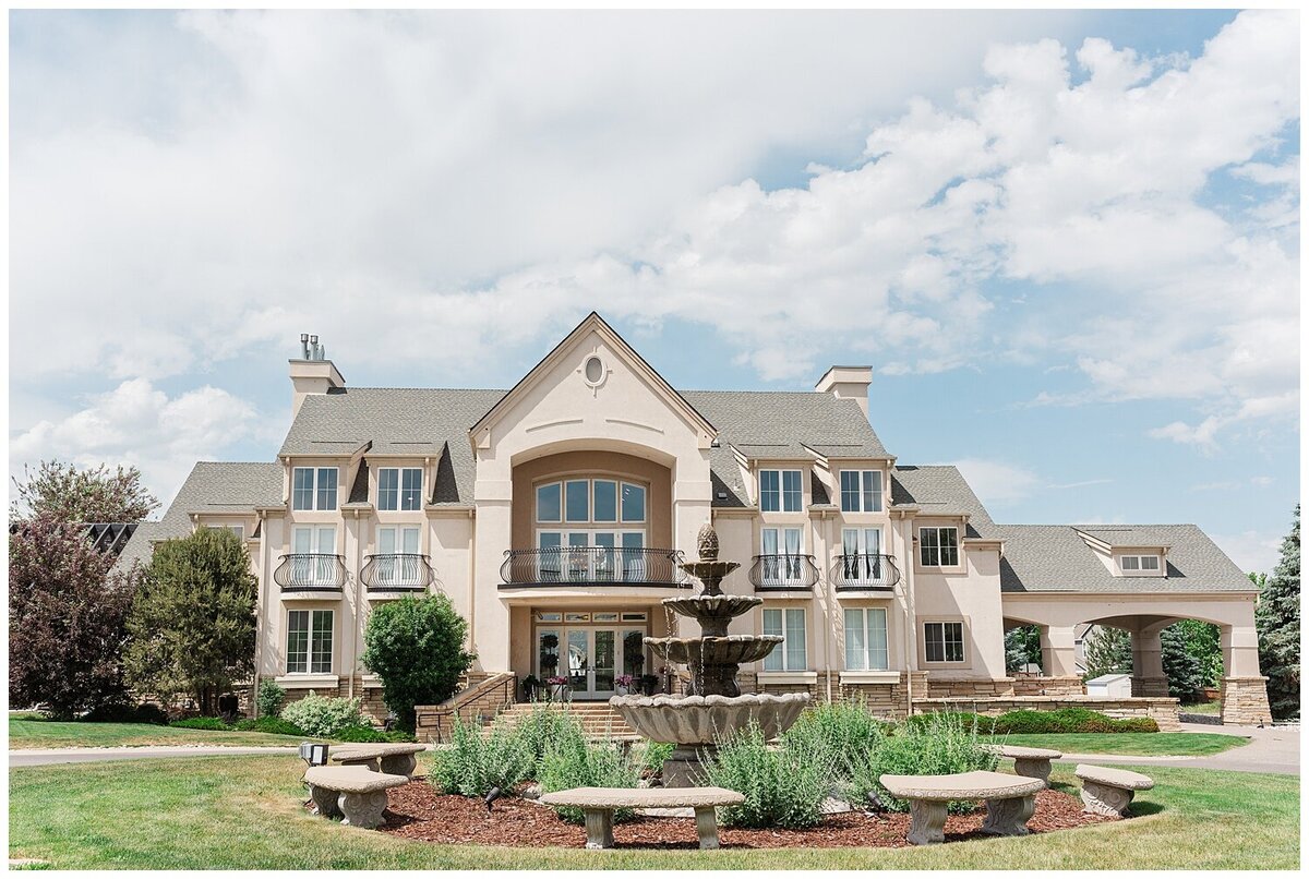 zoomed out shot by denver wedding photographer of the chateaux at fox meadows including the fountain