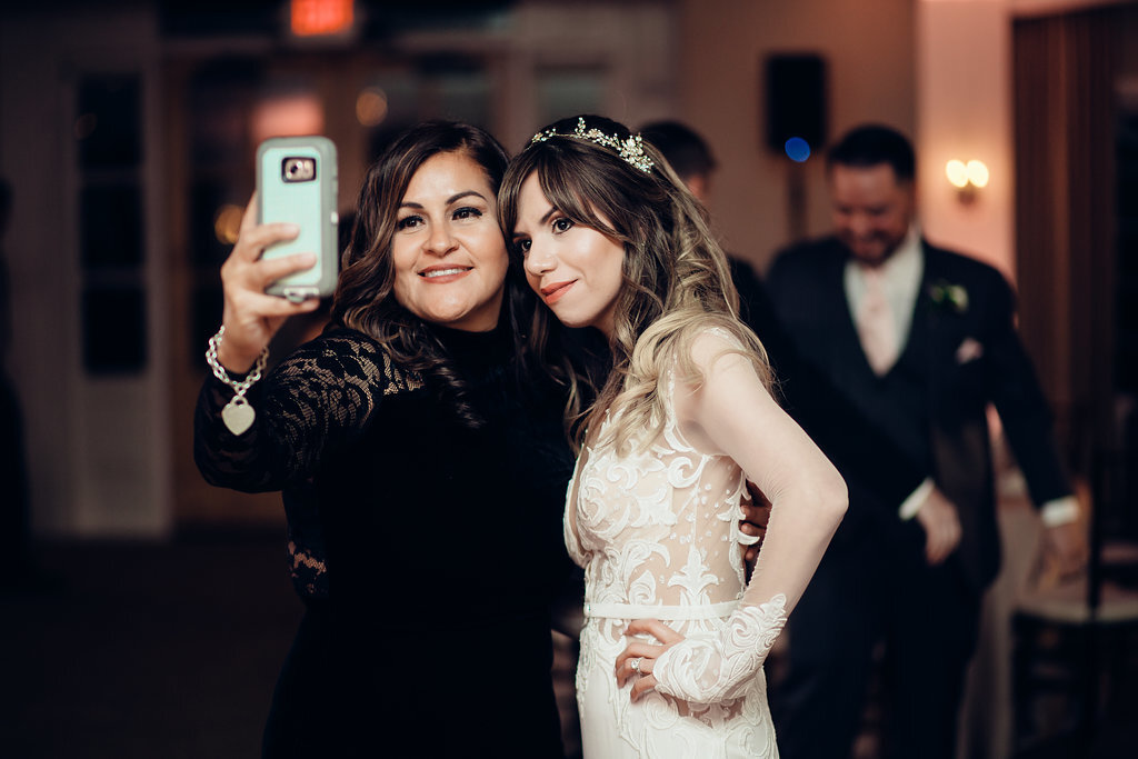 Wedding Photograph Of Bride And a Woman In Black Dress Taking a Selfie Los Angeles
