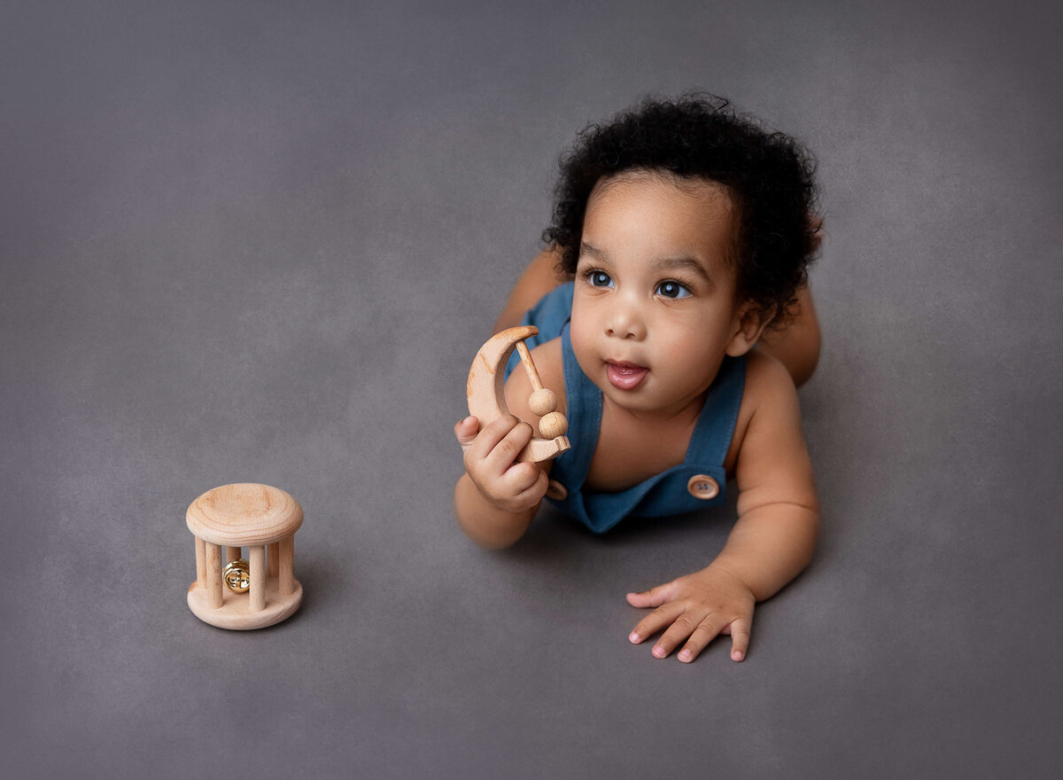 Baby boy playing with wooden toys