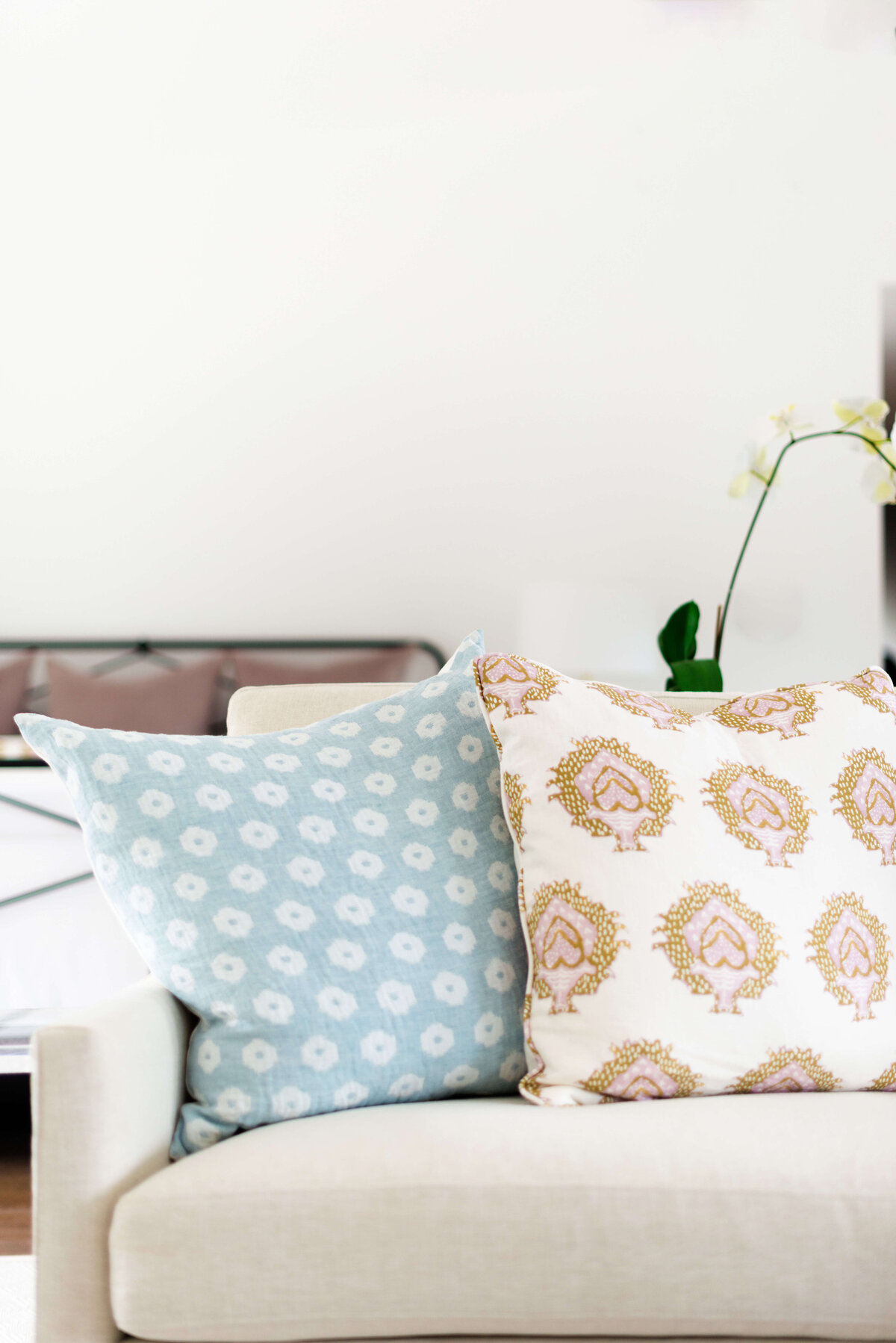 oyster creek studios building belt new build two accent pillows on ivory couch in living room