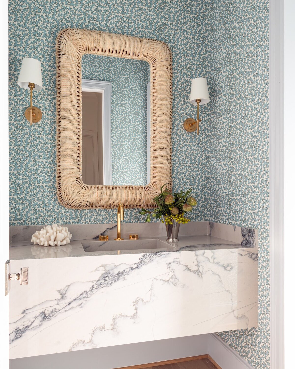 french lab designs bathroom with marble vanity and pattern wallpaper