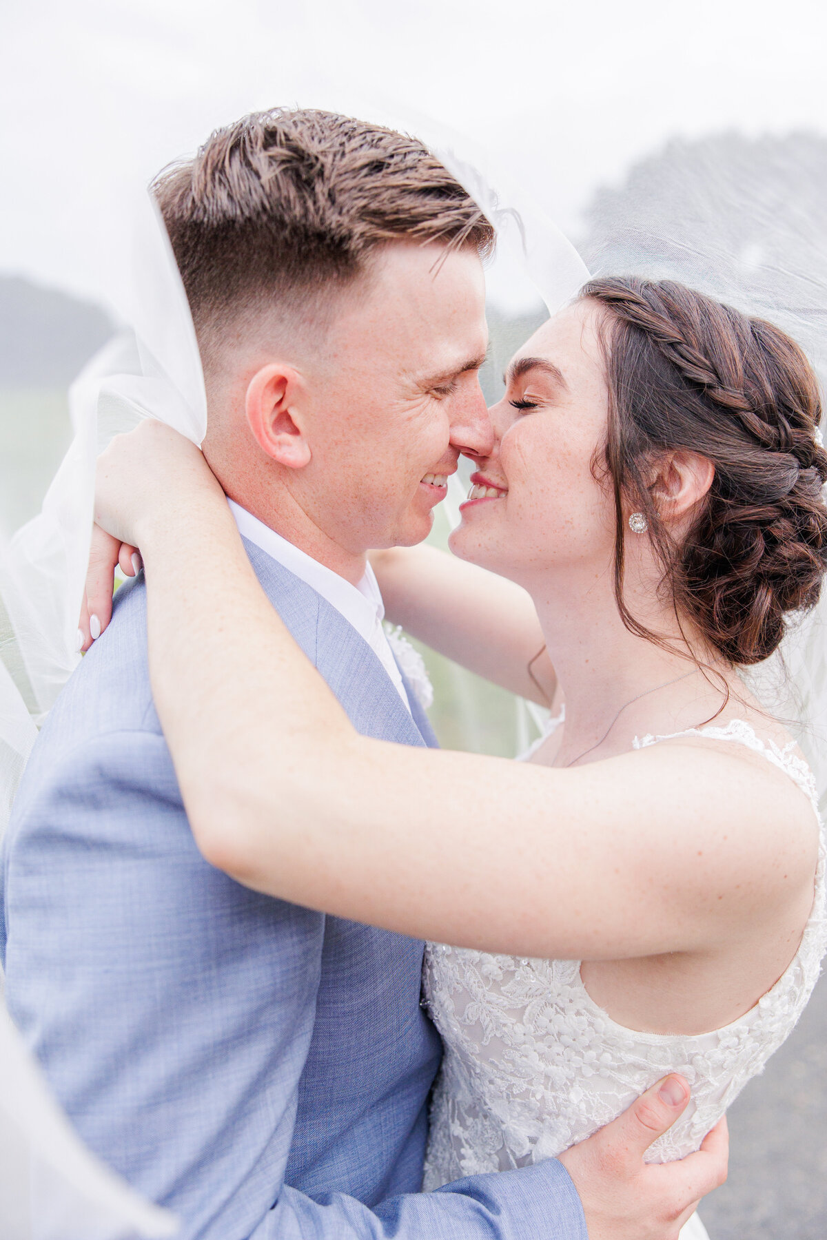 Bride and groom kissing underneath the veil representing the best Boston wedding portraits