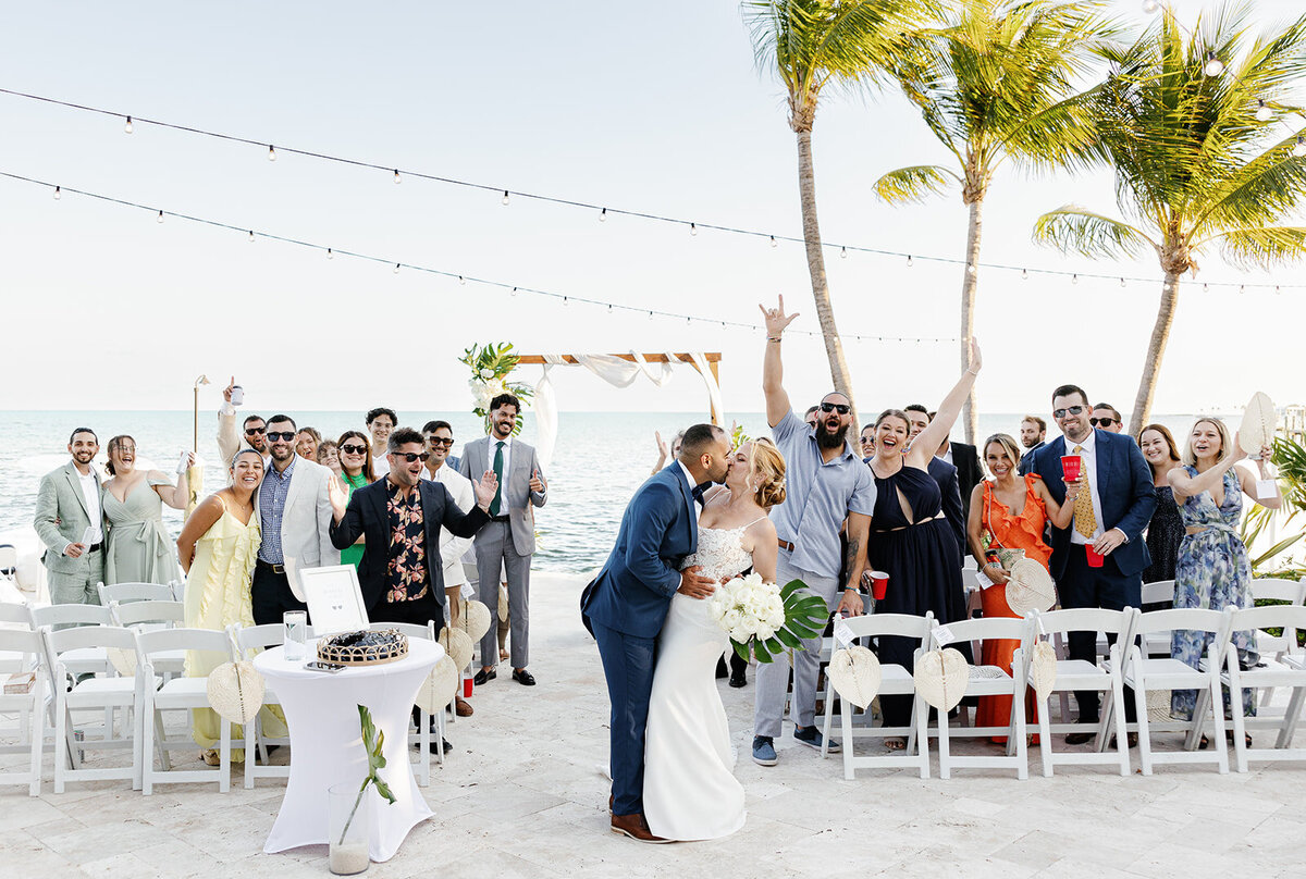 Kelly and Rafael sharing their first kiss as newlyweds at La Siesta Marina Resort.