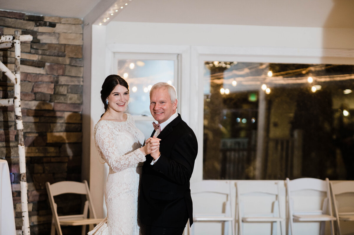 Bride and her dad dance together at the wedding reception captured by Denver wedding photographer KB Radiant Photography