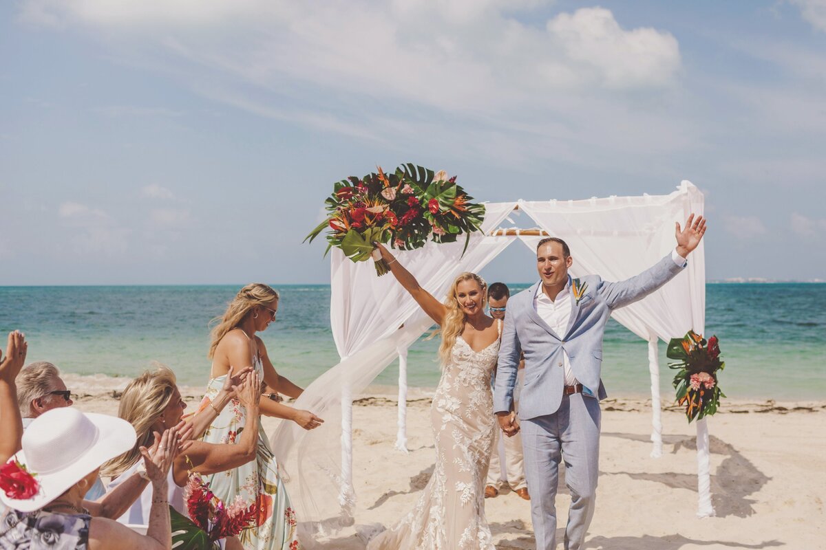 Bride and groom celebrate after getting married in Cancun