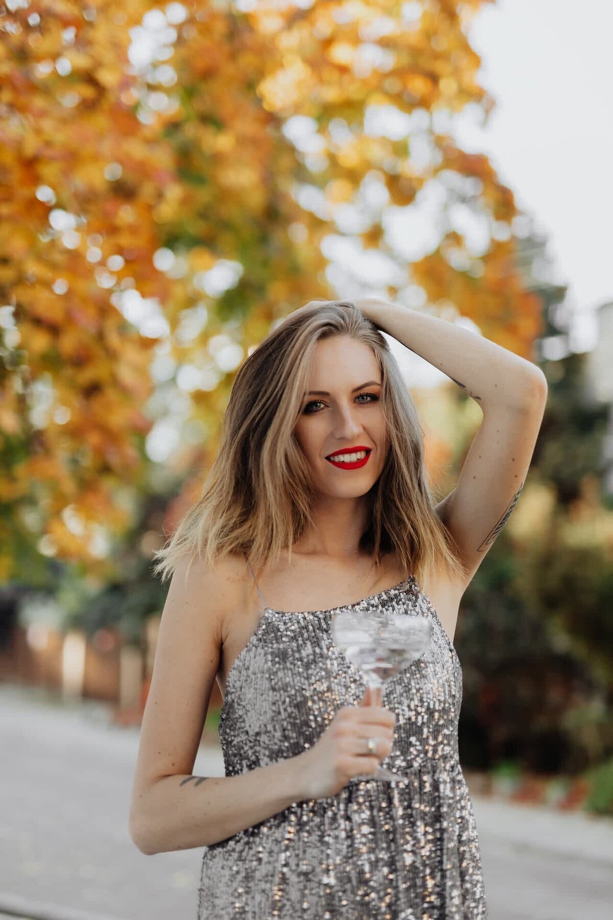 kaboompics_blond-woman-in-a-sequin-dress-is-holding-a-glass-of-champagne-autumn-14699-optimized