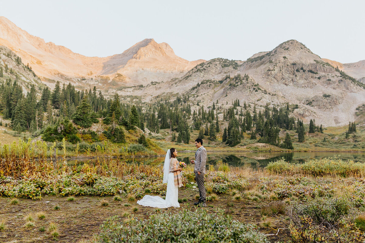 A couple says their vows during their elopement in front of a mountain view in Crested Butte, Colorado