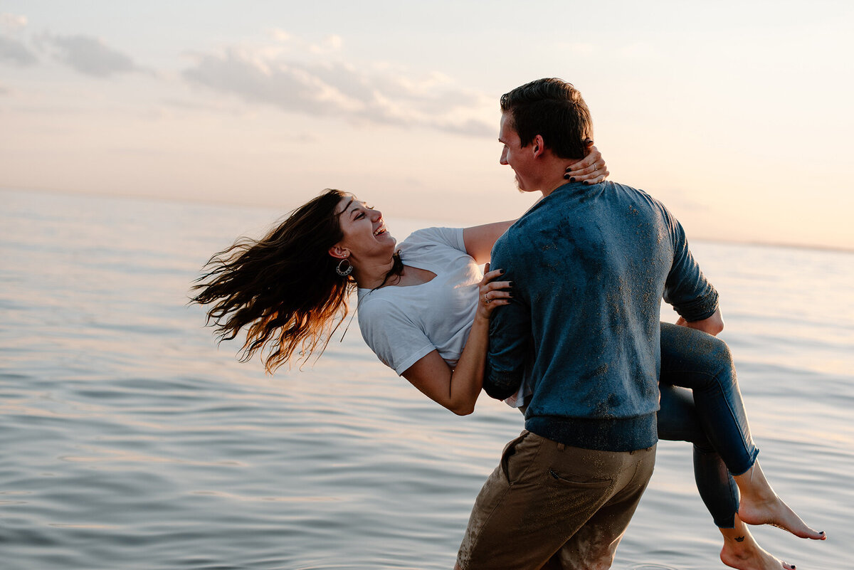 Playful engagement session on the beach
