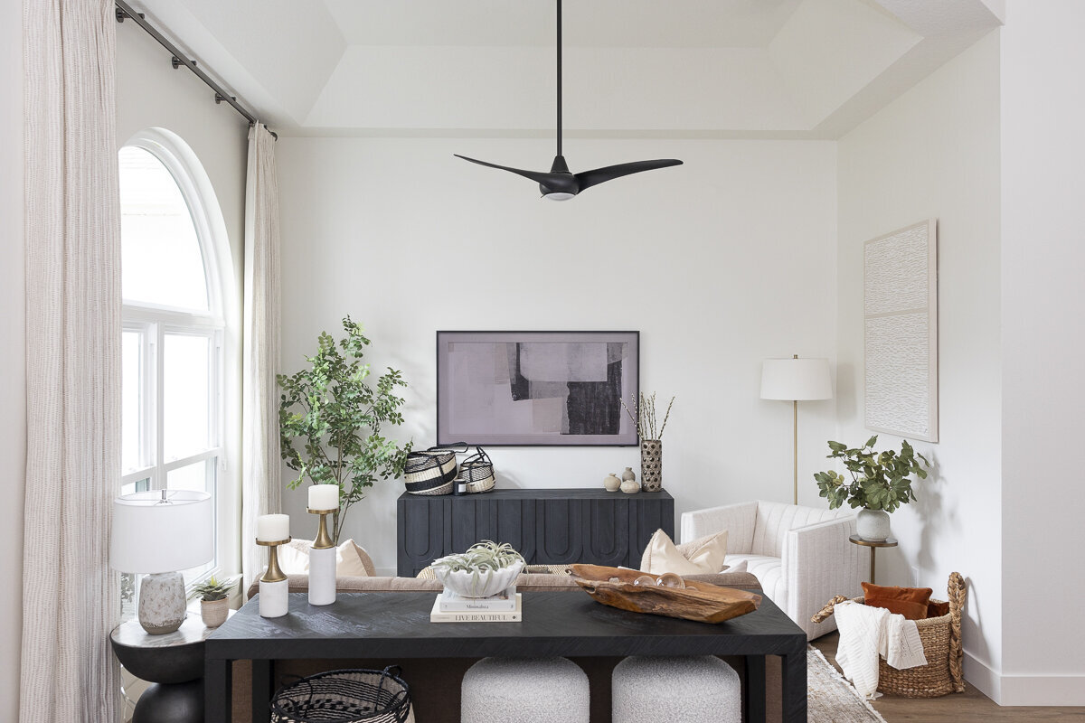 dewine design orlando interior designer belle isle living room with black ceiling fan and long window curtains