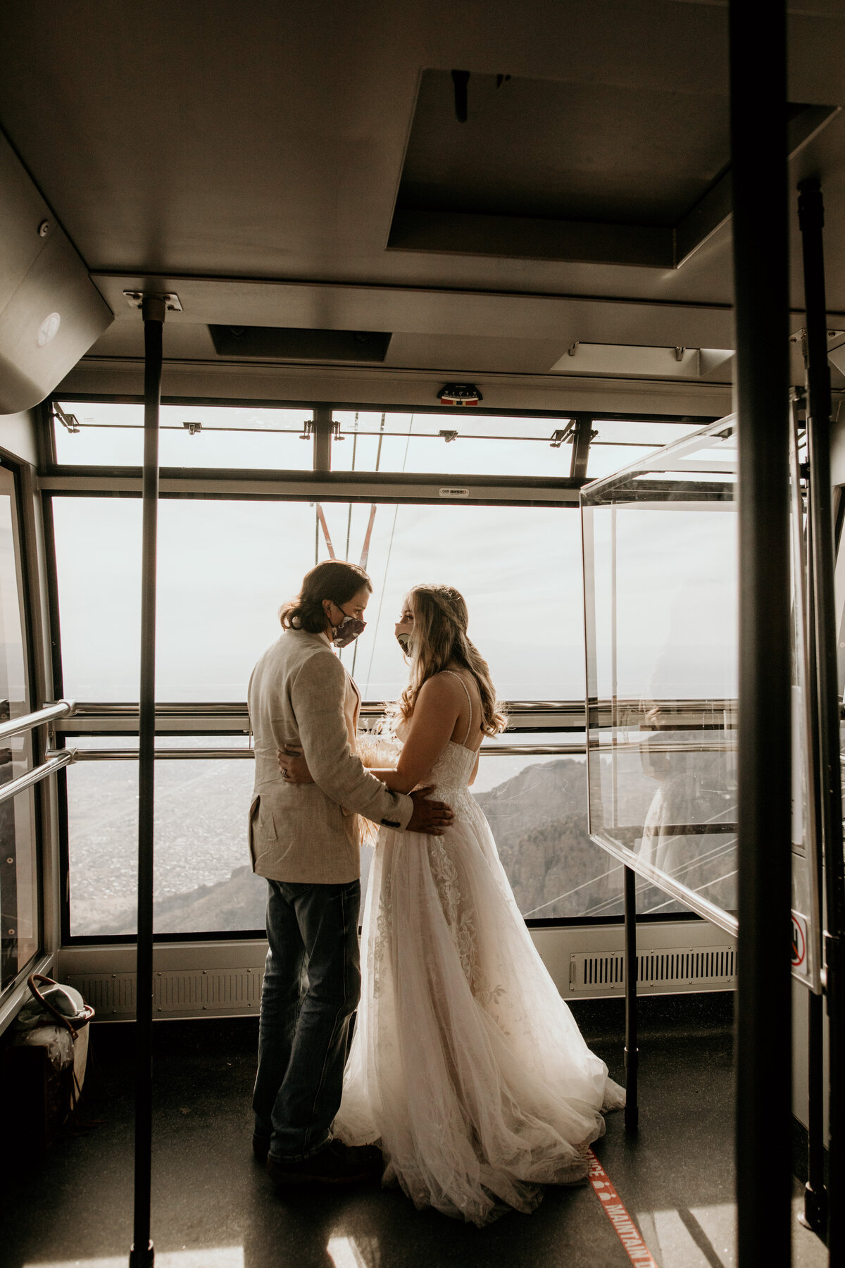 bride and groom riding the sandia peak tram together for their elopement