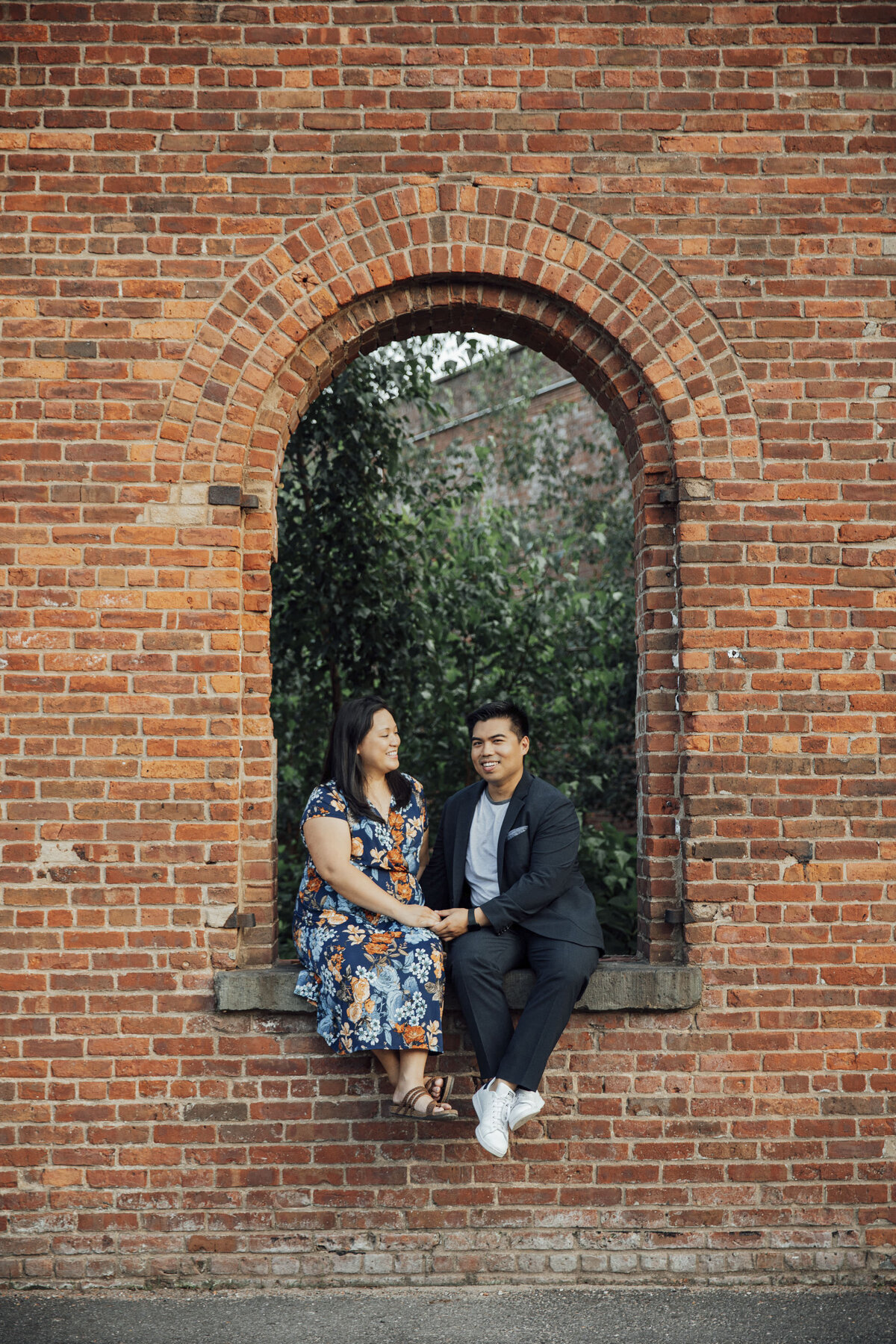 Couple holding hands during summer engagement photo in New York City