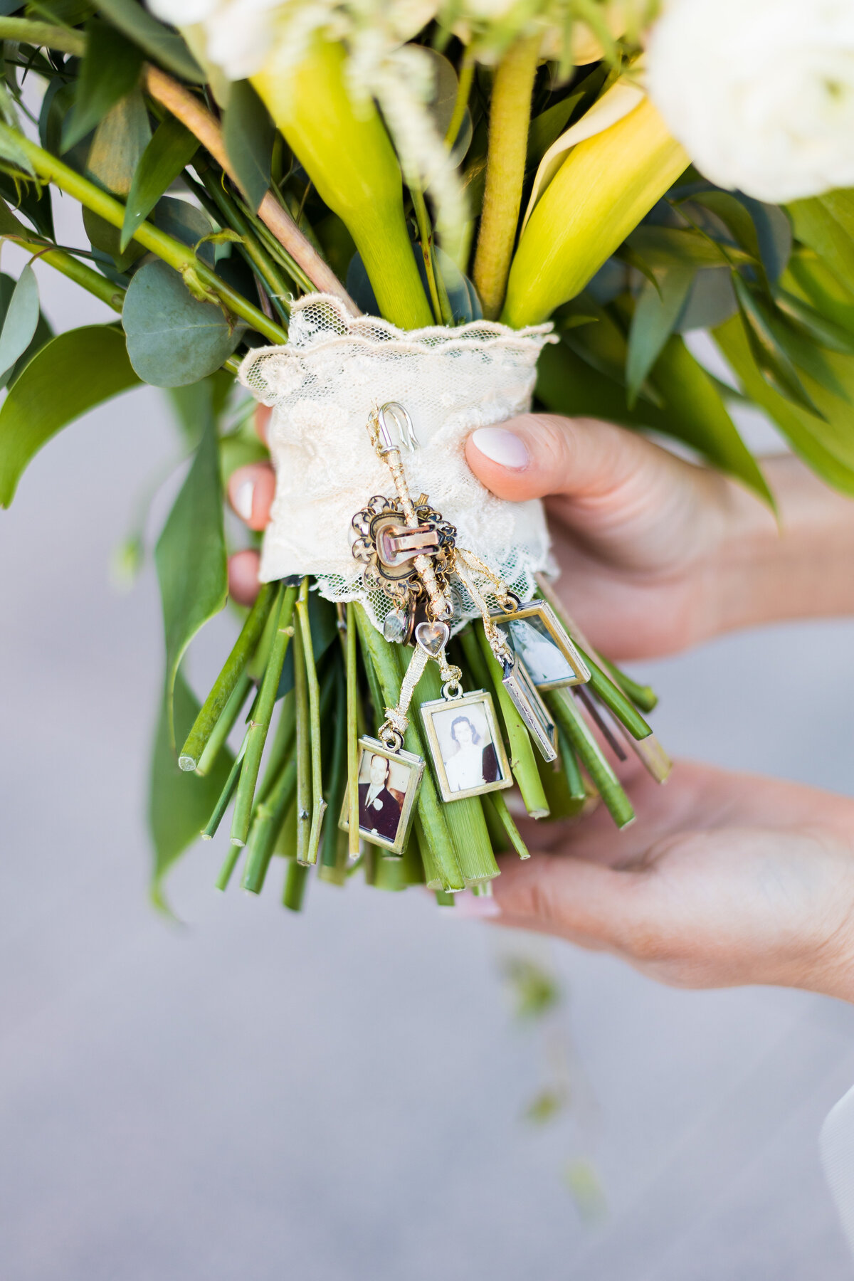 Bride holding bouquet with locket and photos attached