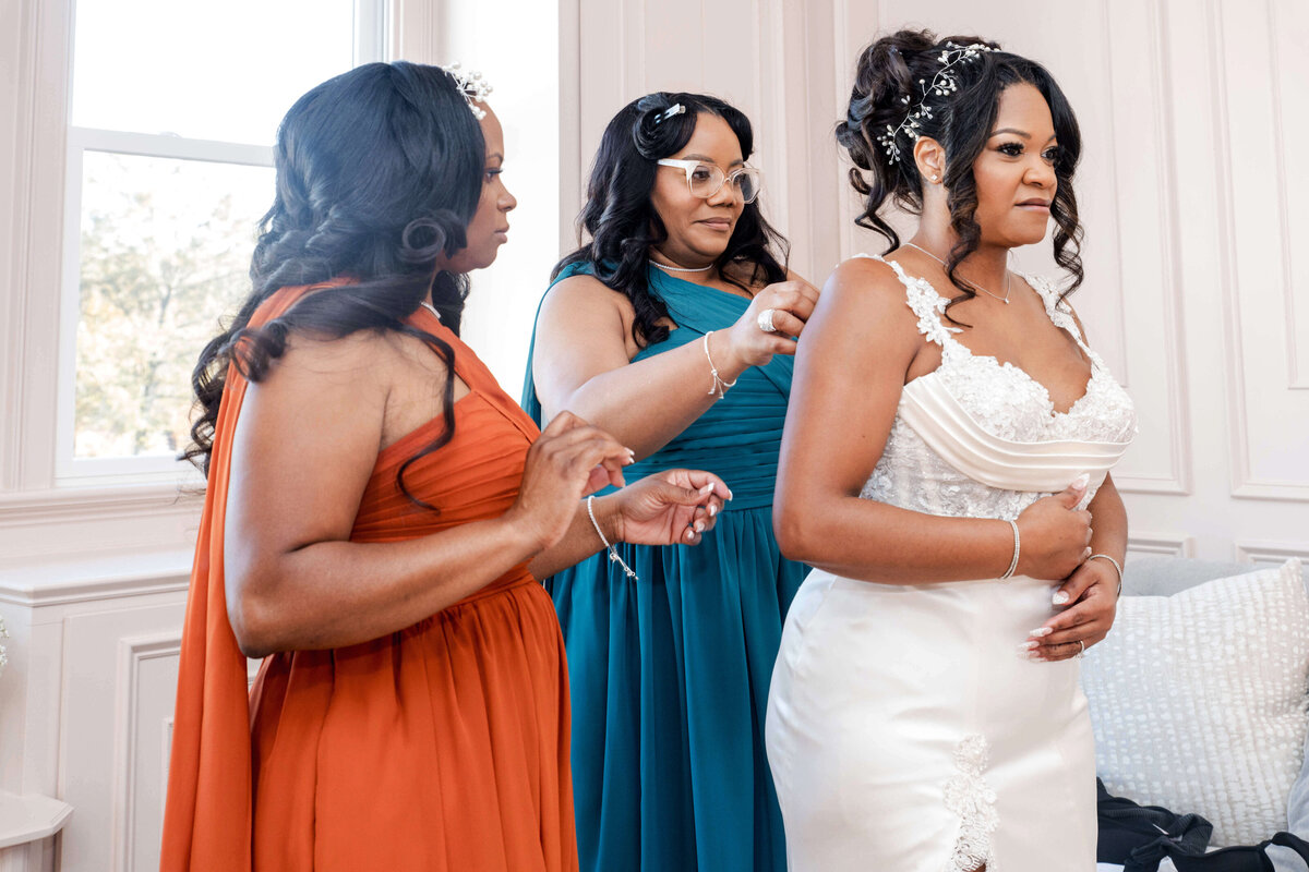 The bride and her bridesmaids share a joyful toast, celebrating their friendship and love.