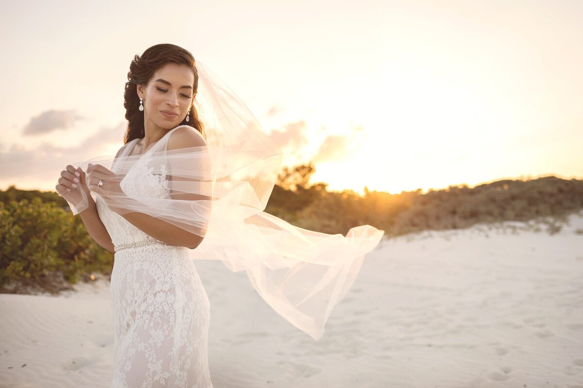 Editorial portrait of bride with sun set behind on beach at Finest Playa Mujeres Cancun