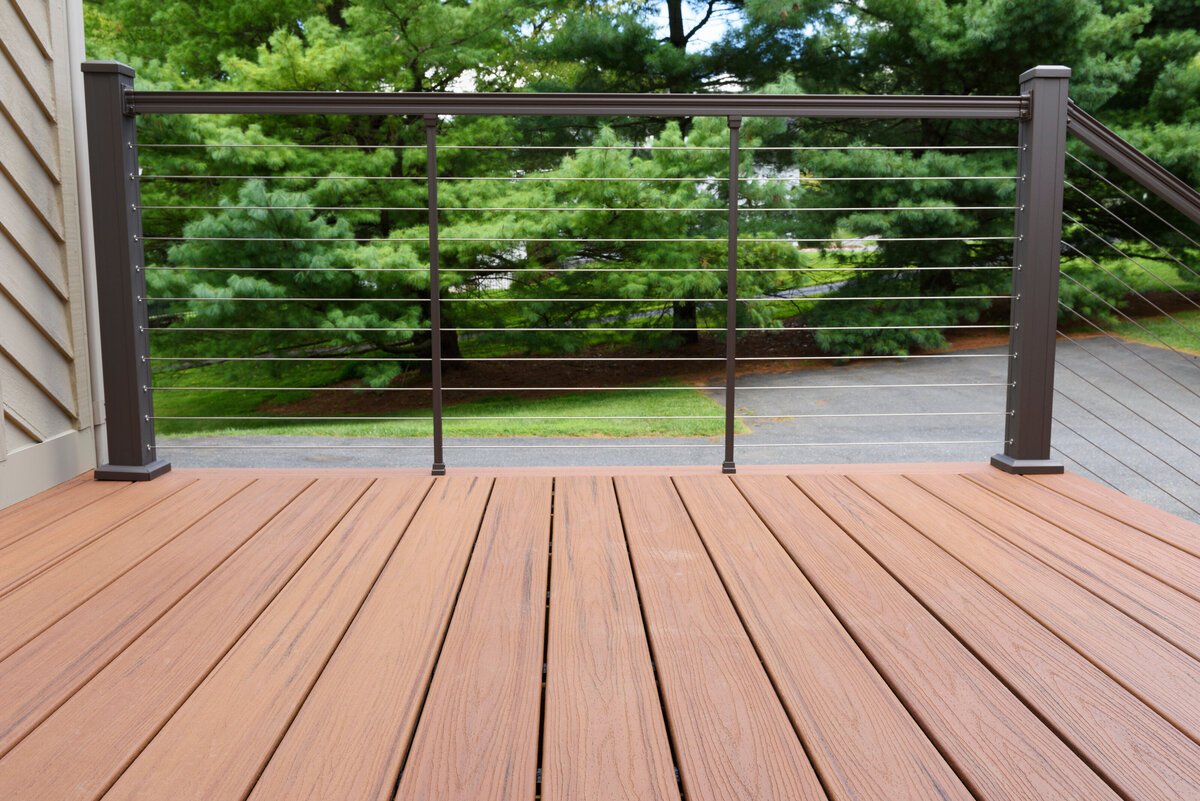 A natural finish composite with brown wire railing