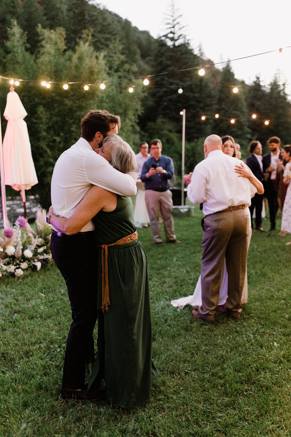 Guests hugging at Dallenbach Ranch Wedding reception Colorado