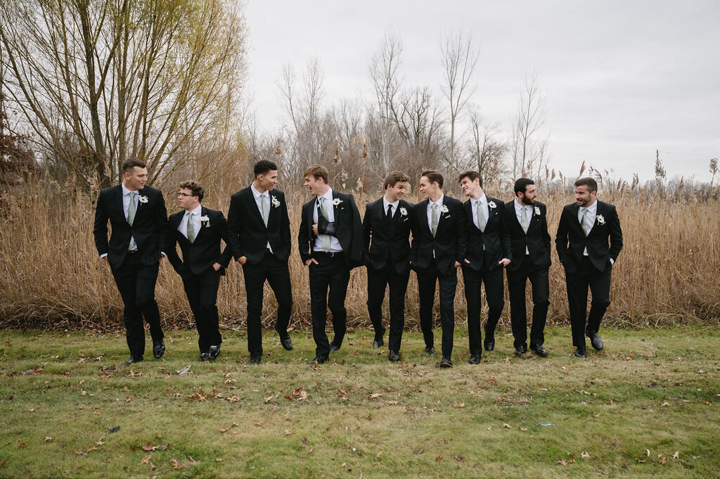 groom walking with groomsmen in a line